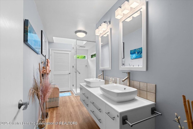 1122 Farwood Dr, East Lansing, MI 48823 - bathroom featuring double vanity and wood finished floors