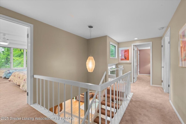 1122 Farwood Dr, East Lansing, MI 48823 - hallway featuring light colored carpet and an upstairs landing