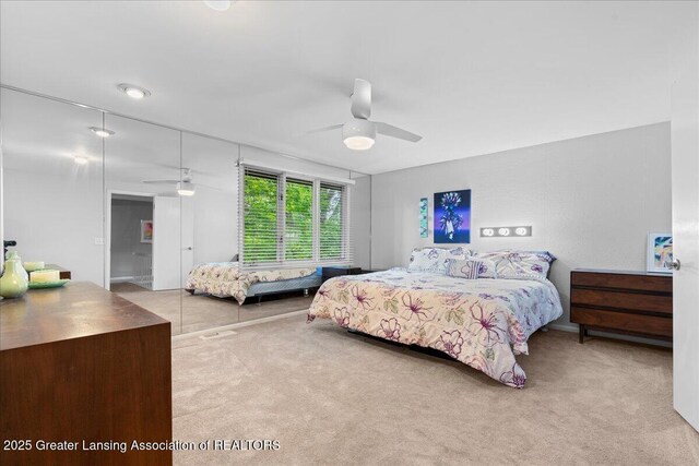 1122 Farwood Dr, East Lansing, MI 48823 - bedroom with carpet, a ceiling fan, and a closet