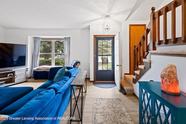 2440 Sower Blvd, Okemos, MI 48864 - living area featuring stairway, a textured ceiling, and light wood-style floors