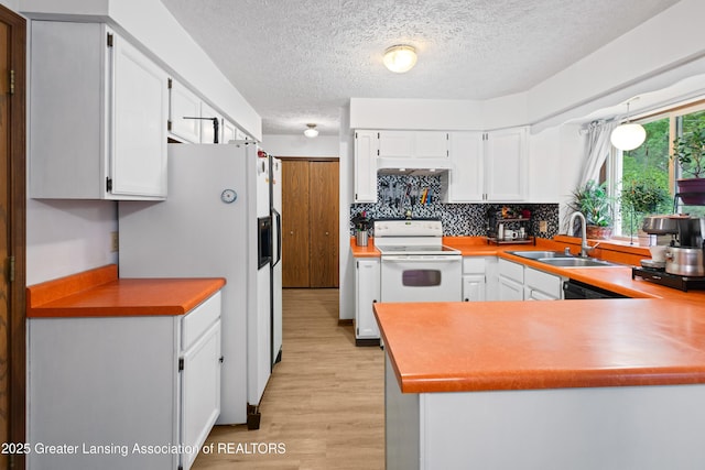 2440 Sower Blvd, Okemos, MI 48864 - kitchen featuring white appliances, a textured ceiling, light wood-type flooring, white cabinets, and a peninsula