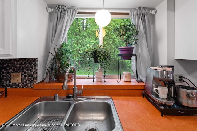 2440 Sower Blvd, Okemos, MI 48864 - kitchen featuring white cabinets and tasteful backsplash