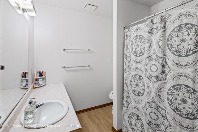 2440 Sower Blvd, Okemos, MI 48864 - full bathroom featuring vanity, wood finished floors, and curtained shower