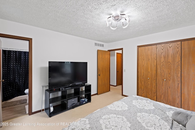 2440 Sower Blvd, Okemos, MI 48864 - bedroom featuring carpet, a closet, ensuite bathroom, and a textured ceiling