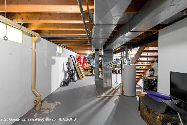 2440 Sower Blvd, Okemos, MI 48864 - below grade area featuring gas water heater, heating unit, and stairway