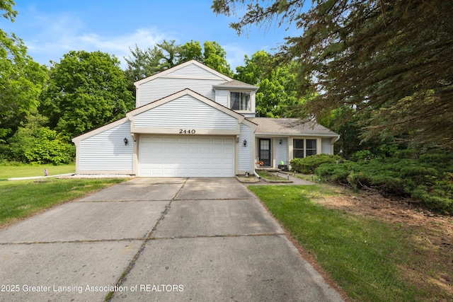 2440 Sower Blvd, Okemos, MI 48864 - traditional-style home featuring an attached garage, a front lawn, concrete driveway, and a shingled roof