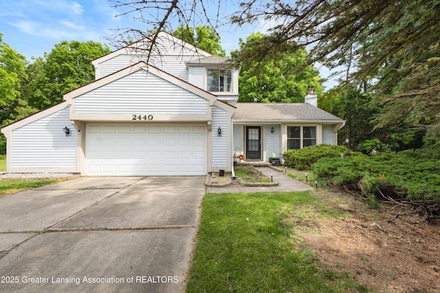 2440 Sower Blvd, Okemos, MI 48864 - traditional home with a garage, concrete driveway, a chimney, and a shingled roof