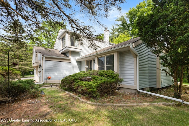 2440 Sower Blvd, Okemos, MI 48864 - view of side of property with a chimney and a shingled roof