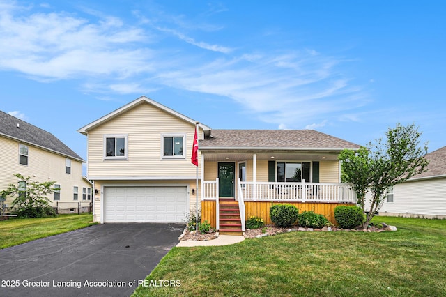 242 Coventry Ln, Mason, MI 48854 - split level home with covered porch, an attached garage, asphalt driveway, and a front yard