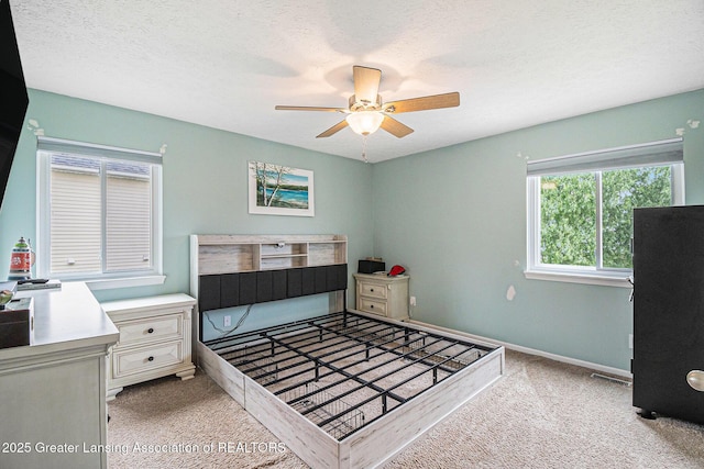 242 Coventry Ln, Mason, MI 48854 - bedroom with light carpet, ceiling fan, and a textured ceiling