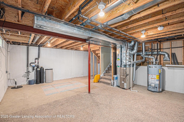 242 Coventry Ln, Mason, MI 48854 - unfinished below grade area with water heater, stairs, a water softener, and heating unit