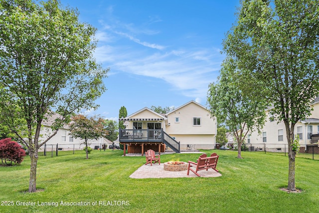242 Coventry Ln, Mason, MI 48854 - back of property with a fire pit, a wooden deck, and stairway