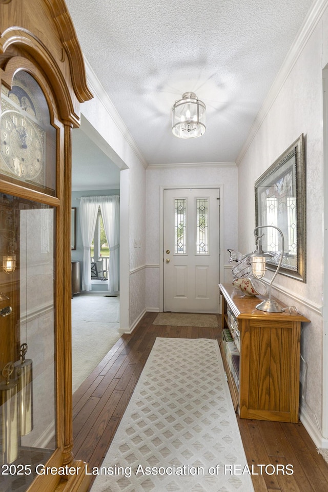 2352 Kings Cross N, East Lansing, MI 48823 - foyer entrance featuring hardwood / wood-style floors, crown molding, a chandelier, and a textured ceiling