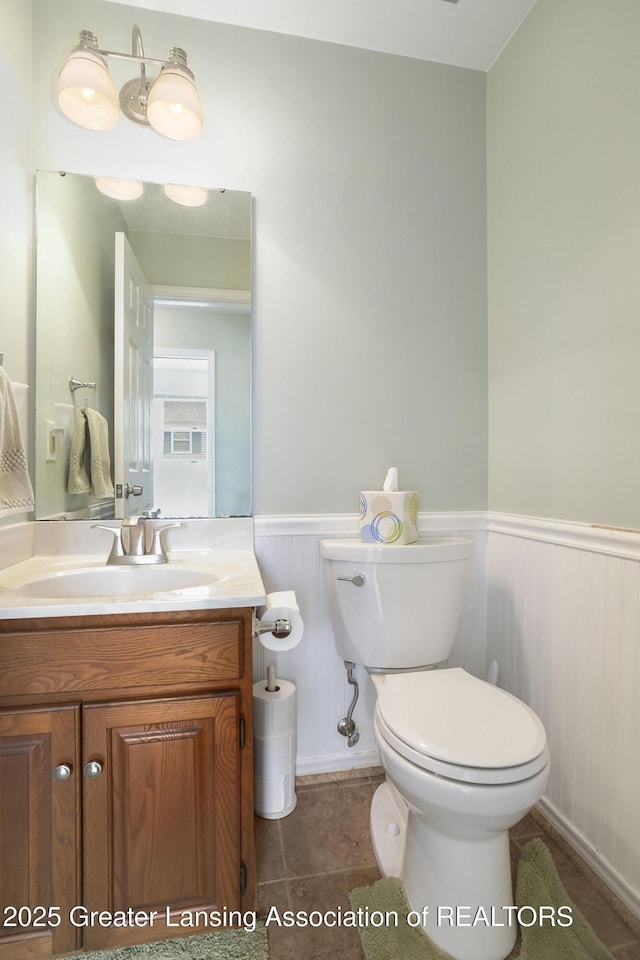 2352 Kings Cross N, East Lansing, MI 48823 - bathroom featuring wainscoting, vanity, and tile patterned flooring