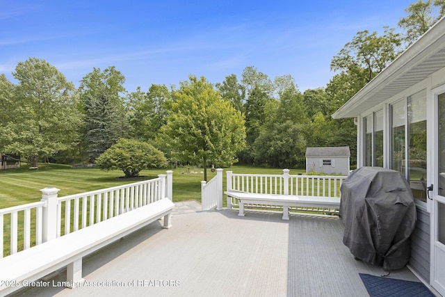 2352 Kings Cross N, East Lansing, MI 48823 - view of patio featuring a wooden deck, a storage shed, area for grilling, and view of scattered trees