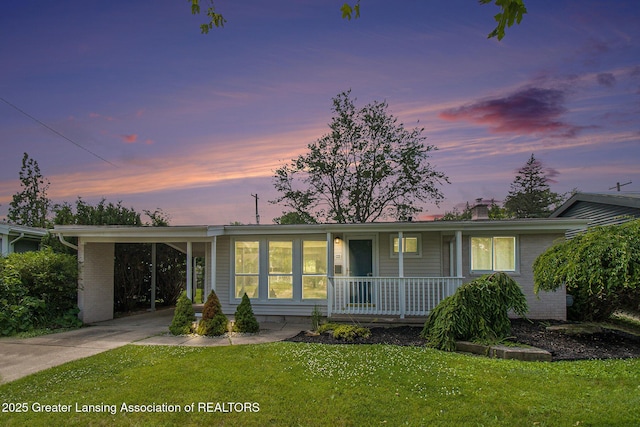 1321 Weber Dr, Lansing, MI 48912 - single story home featuring a porch, driveway, a front yard, a chimney, and an attached carport