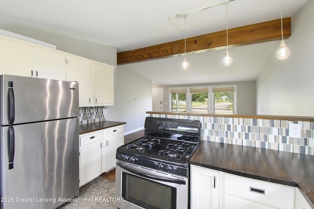 1321 Weber Dr, Lansing, MI 48912 - kitchen featuring appliances with stainless steel finishes, dark countertops, backsplash, beam ceiling, and white cabinetry