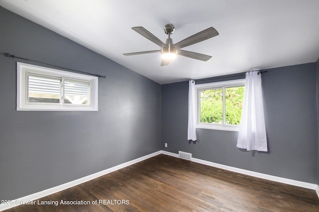 1321 Weber Dr, Lansing, MI 48912 - empty room featuring lofted ceiling, dark wood-type flooring, and ceiling fan