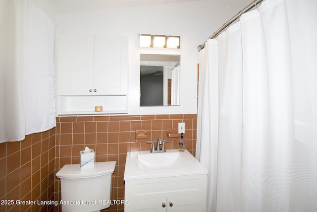 1321 Weber Dr, Lansing, MI 48912 - bathroom with vanity, tile walls, and a wainscoted wall