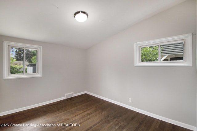 1321 Weber Dr, Lansing, MI 48912 - empty room featuring dark wood finished floors and lofted ceiling
