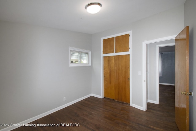 1321 Weber Dr, Lansing, MI 48912 - unfurnished bedroom with dark wood-style floors and a closet