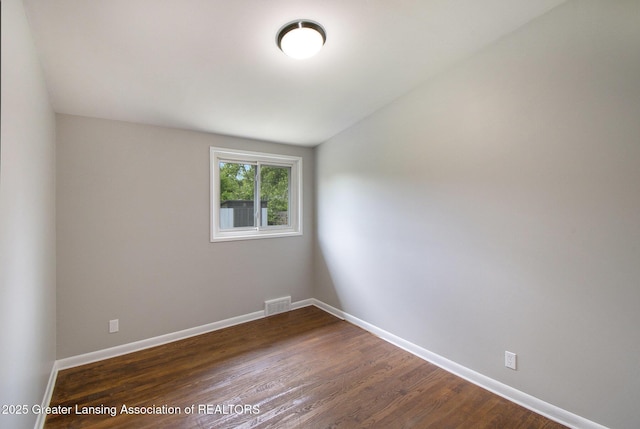 1321 Weber Dr, Lansing, MI 48912 - spare room featuring dark wood-style flooring and baseboards