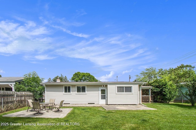 1321 Weber Dr, Lansing, MI 48912 - back of property with a patio, a fenced backyard, and a chimney
