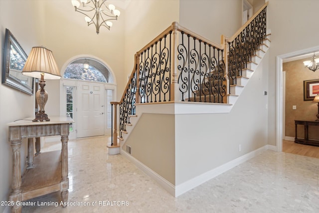 6378 E Island Lake Dr, East Lansing, MI 48823 - entryway featuring a chandelier, a towering ceiling, and stairs
