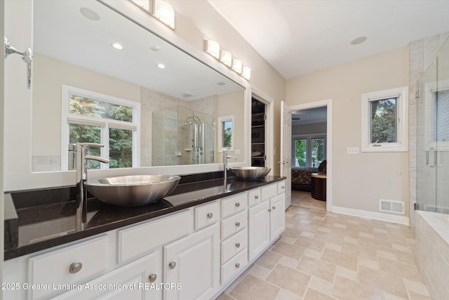 6378 E Island Lake Dr, East Lansing, MI 48823 - ensuite bathroom with double vanity, a stall shower, and recessed lighting