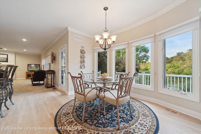 6378 E Island Lake Dr, East Lansing, MI 48823 - dining space with light wood-type flooring, a chandelier, ornamental molding, and recessed lighting