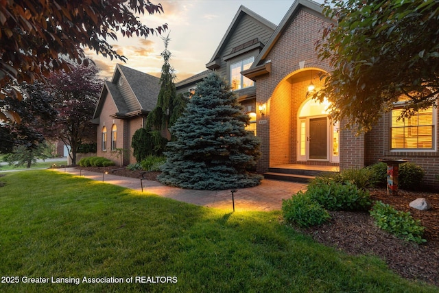 6378 E Island Lake Dr, East Lansing, MI 48823 - view of front of house featuring brick siding and a front yard