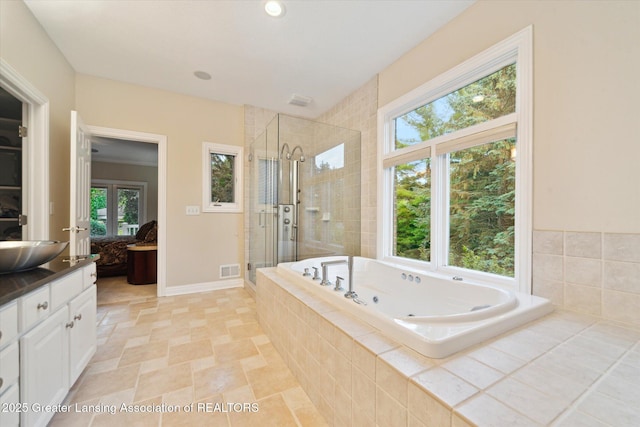 6378 E Island Lake Dr, East Lansing, MI 48823 - full bath featuring a stall shower, vanity, and a jetted tub