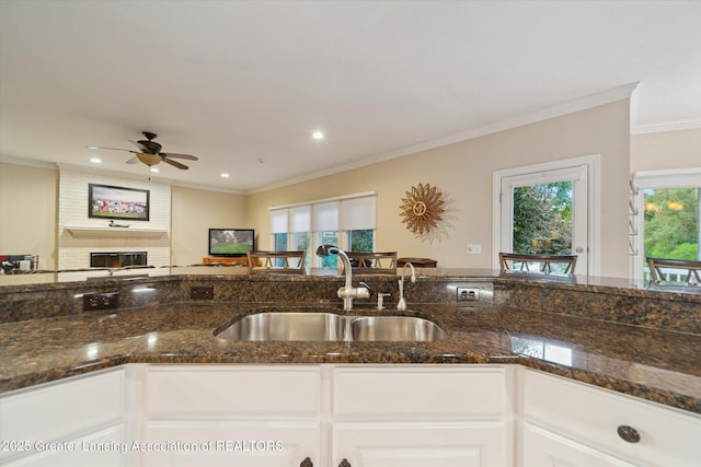 6378 E Island Lake Dr, East Lansing, MI 48823 - kitchen featuring dark stone countertops, a ceiling fan, healthy amount of natural light, crown molding, and recessed lighting