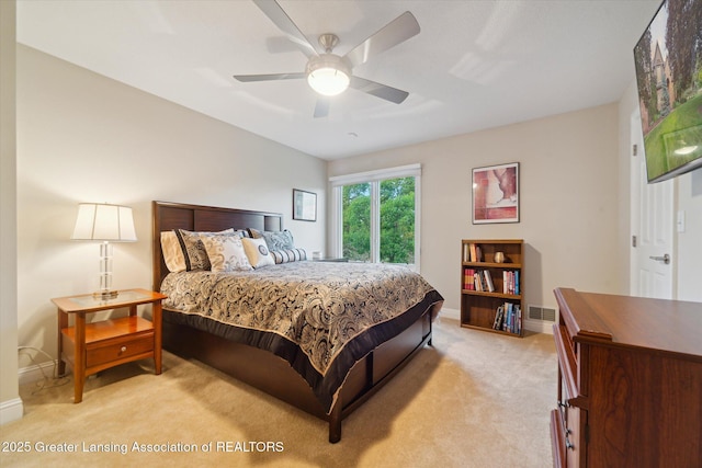 6378 E Island Lake Dr, East Lansing, MI 48823 - bedroom with light carpet and a ceiling fan