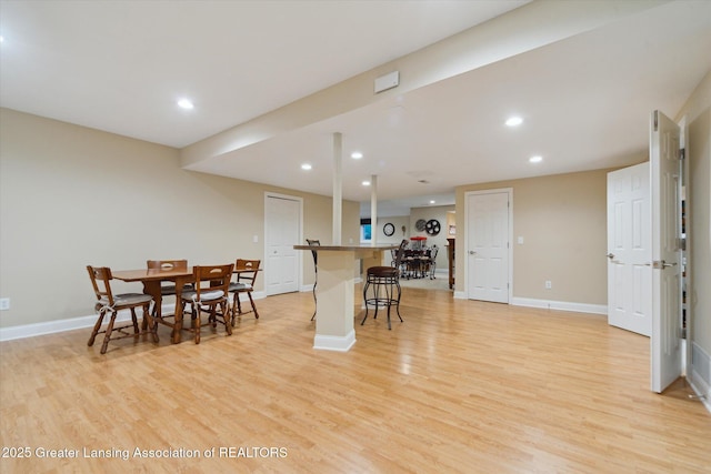 6378 E Island Lake Dr, East Lansing, MI 48823 - dining area featuring light wood-style floors, recessed lighting, and bar