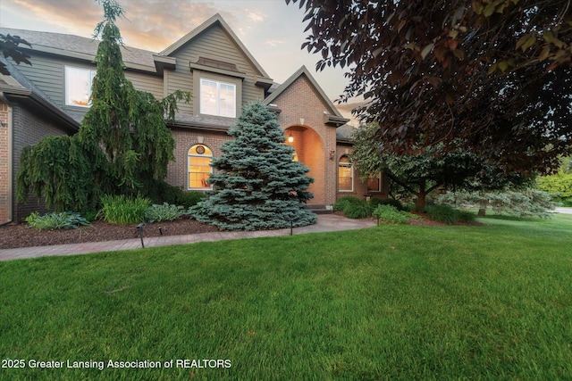 6378 E Island Lake Dr, East Lansing, MI 48823 - view of front of home featuring brick siding and a front yard