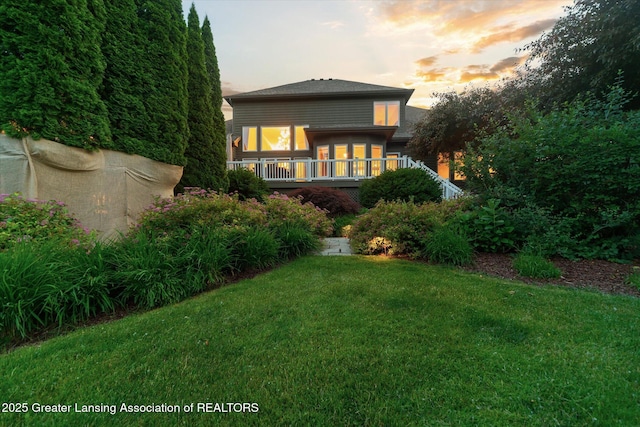 6378 E Island Lake Dr, East Lansing, MI 48823 - rear view of house featuring a lawn and a deck