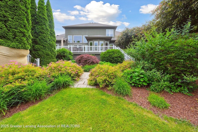 6378 E Island Lake Dr, East Lansing, MI 48823 - back of property featuring a deck and a lawn