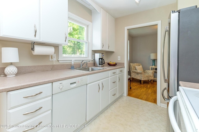 619 Wayland Ave, East Lansing, MI 48823 - kitchen featuring white appliances, white cabinets, and light countertops