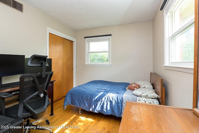 619 Wayland Ave, East Lansing, MI 48823 - bedroom with wood finished floors, a desk, and a closet