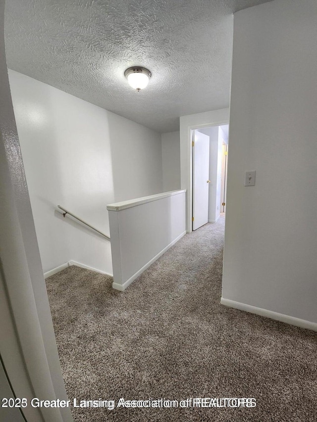 1755 Maisonette Dr, Lansing, MI 48911 - hall featuring an upstairs landing, carpet floors, and a textured ceiling