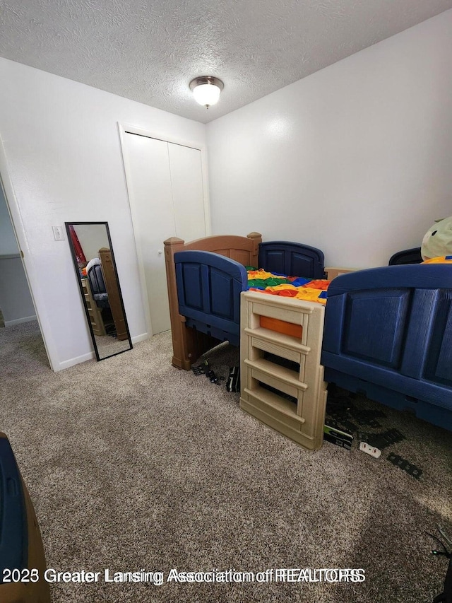 1755 Maisonette Dr, Lansing, MI 48911 - carpeted bedroom with a closet and a textured ceiling