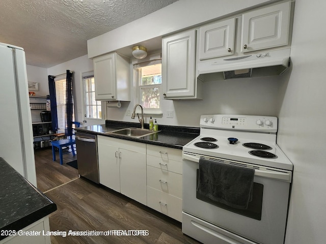 1755 Maisonette Dr, Lansing, MI 48911 - kitchen featuring white appliances, under cabinet range hood, dark wood-type flooring, white cabinets, and dark countertops