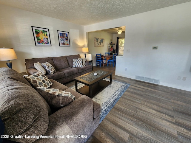 1755 Maisonette Dr, Lansing, MI 48911 - living room with wood finished floors, a textured ceiling, and a ceiling fan