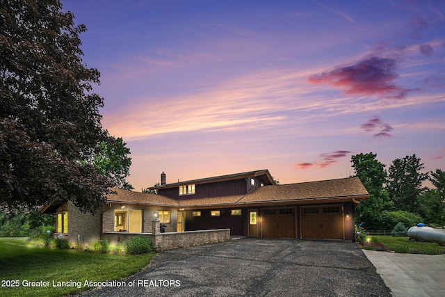 203 Branson Bay Dr, Mason, MI 48854 - view of front facade with an attached garage, driveway, a yard, and a chimney