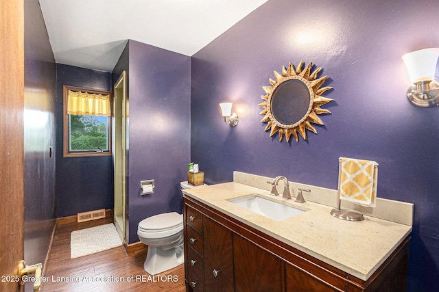 203 Branson Bay Dr, Mason, MI 48854 - bathroom featuring wood finished floors, vanity, and a shower