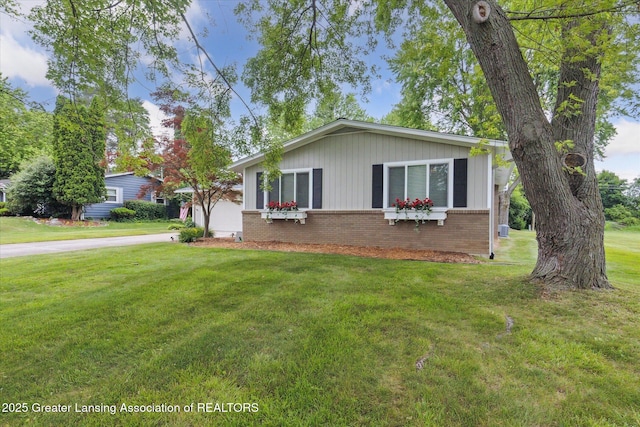 2130 Belding Ct, Okemos, MI 48864 - view of front of property with brick siding, a front lawn, and concrete driveway