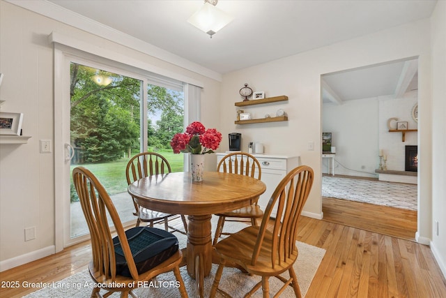 2130 Belding Ct, Okemos, MI 48864 - dining space featuring a large fireplace and light wood-style flooring