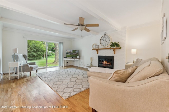 2130 Belding Ct, Okemos, MI 48864 - living room with a fireplace, a ceiling fan, light wood-style floors, and beam ceiling