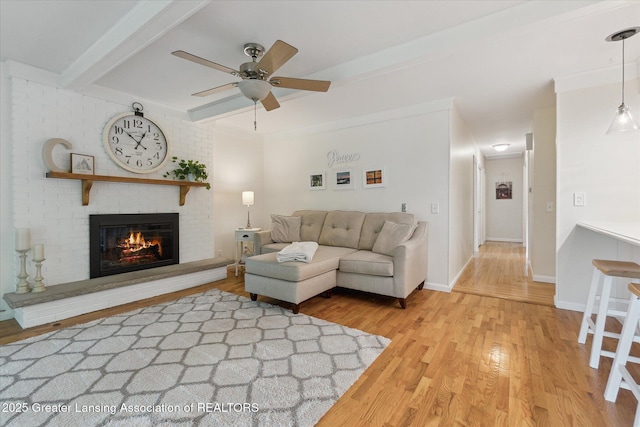 2130 Belding Ct, Okemos, MI 48864 - living room featuring wood finished floors, a fireplace, a ceiling fan, and beam ceiling